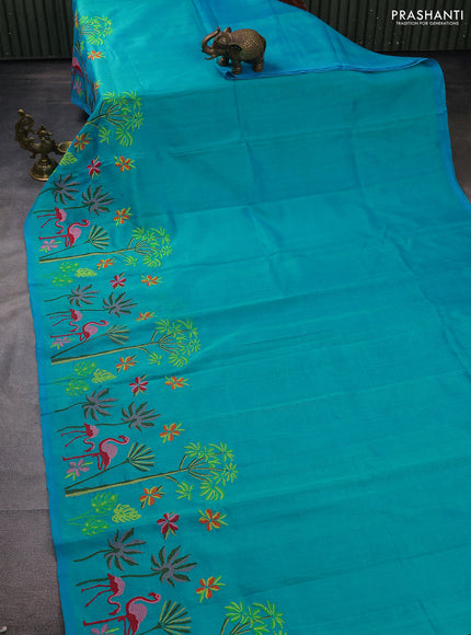 Silk cotton saree dual shade of teal blue with plain body and long kutchi embroidery border