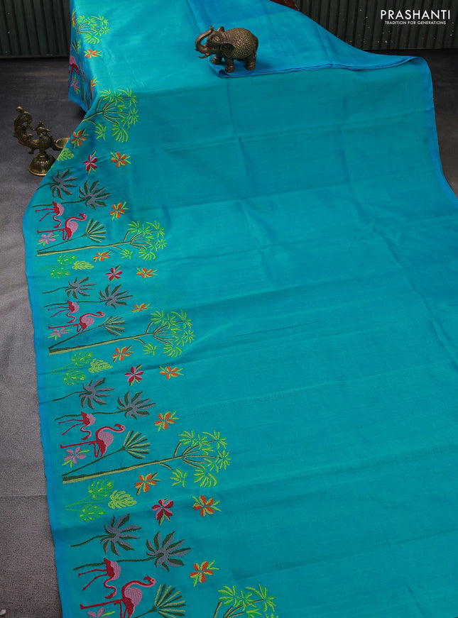 Silk cotton saree dual shade of teal blue with plain body and long kutchi embroidery border