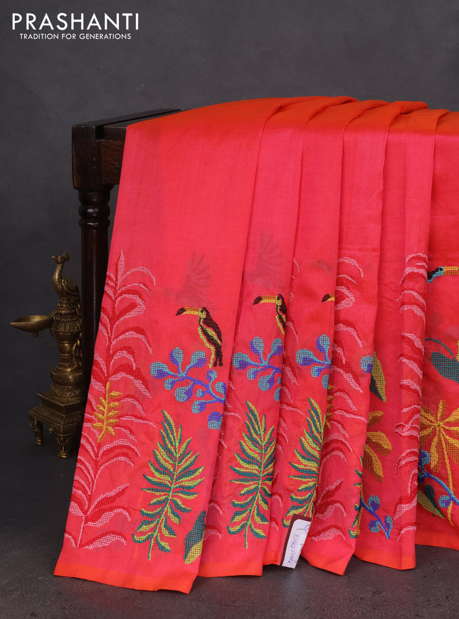 Silk cotton saree dual shade of pinkish orange with plain body and long kutchi embroidery border