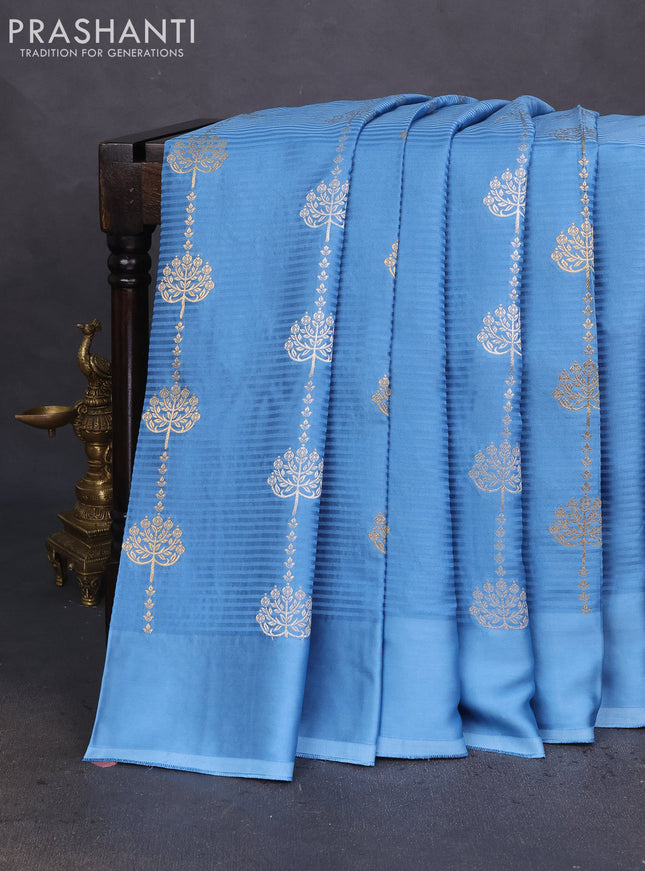 Banarasi mushru silk saree light blue with allover stripes pattern & zari buttas and satin border