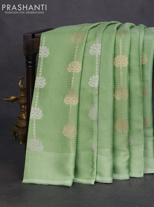 Banarasi mushru silk saree pastel green with allover stripes pattern & zari buttas and satin border