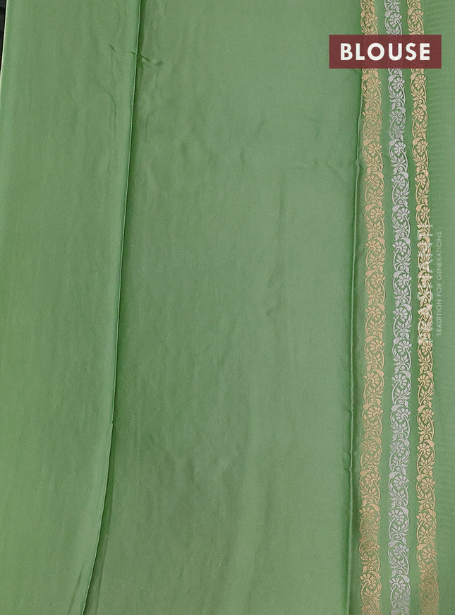 Banarasi mushru silk saree pastel green with allover stripes pattern & zari buttas and satin border