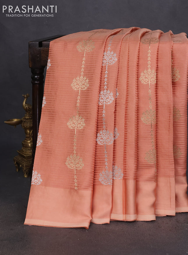 Banarasi mushru silk saree pale orange with allover stripes pattern & zari buttas and satin border