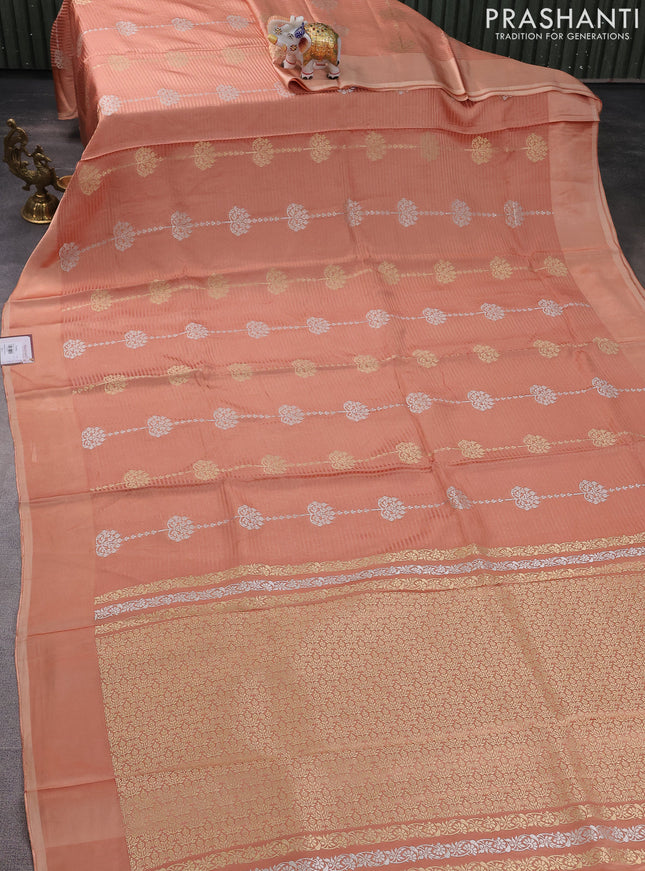 Banarasi mushru silk saree pale orange with allover stripes pattern & zari buttas and satin border