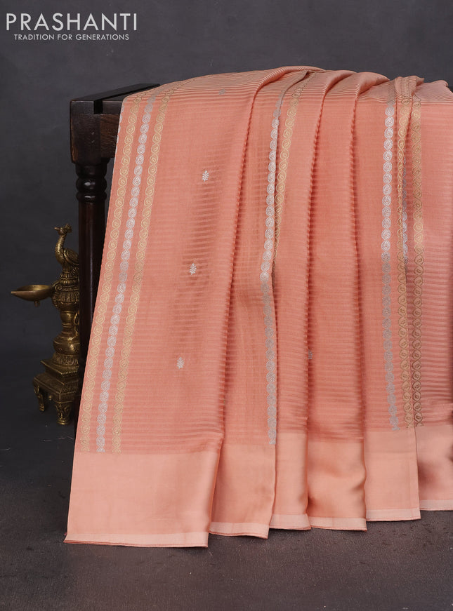 Banarasi mushru silk saree peach shade with allover stripes pattern & zari weaves and satin border