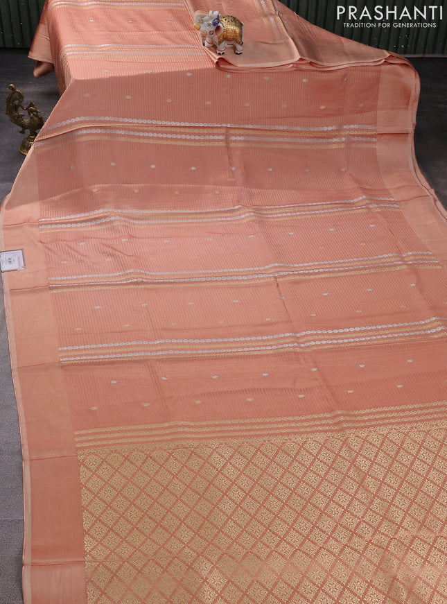 Banarasi mushru silk saree peach shade with allover stripes pattern & zari weaves and satin border