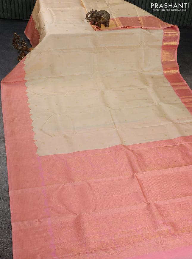 Pure kanchipuram silk saree cream and dual shade of peach with zari woven buttas and rich zari woven border