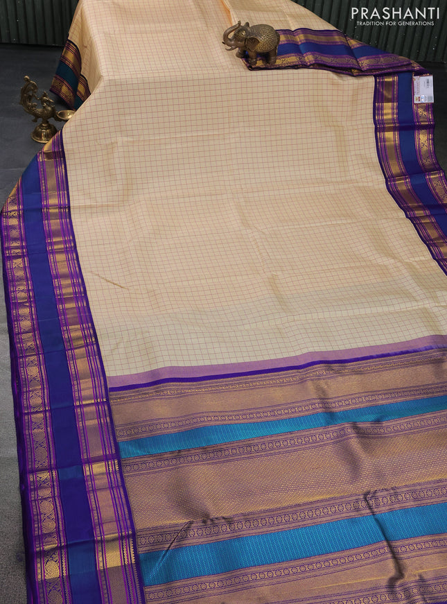 Pure kanchipuram silk saree cream and blue with allover checked pattern and rettapet zari woven border
