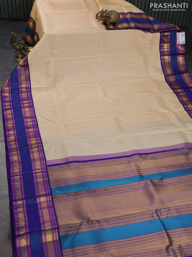 Pure kanchipuram silk saree cream and blue with allover checked pattern and rettapet zari woven border