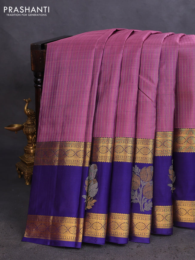 Pure kanchipuram silk saree pastel purple and dark blue with allover zari weaves and long zari woven butta border