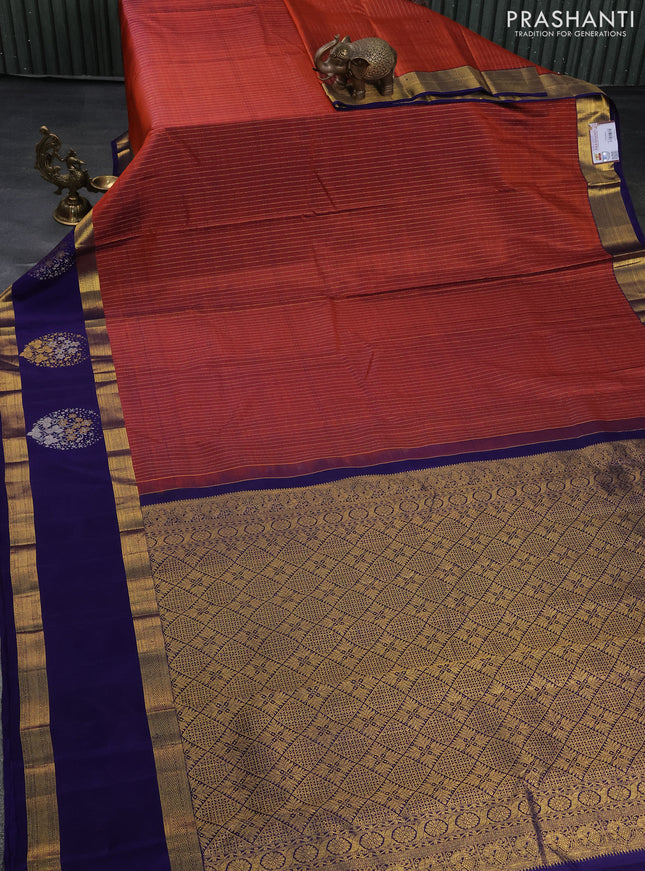 Pure kanchipuram silk saree rustic orange and dark blue with allover zari weaves and long zari woven butta border
