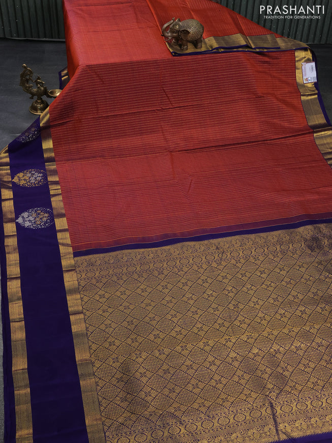 Pure kanchipuram silk saree rustic orange and dark blue with allover zari weaves and long zari woven butta border