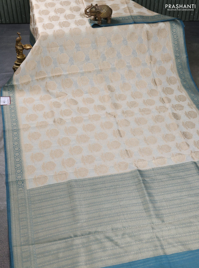 Banarasi silk cotton saree off white and peacock blue with allover thread & zari woven butta weaves and woven border