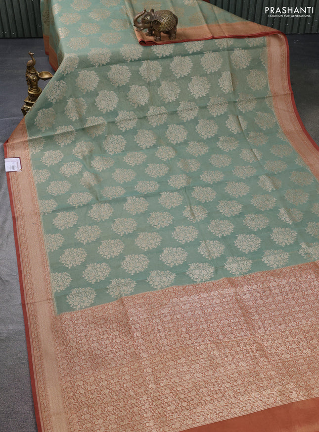 Banarasi tissue silk cotton saree pastel green and rust shade with allover thread & zari woven butta weaves and woven border