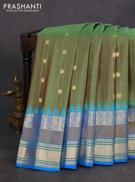 Pure gadwal silk saree green shade and cs blue with zari woven buttas and rettapet annam zari woven border