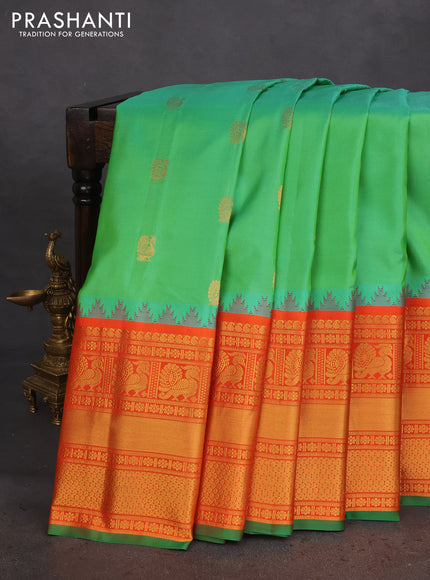 Pure gadwal silk saree light green and orange with annam zari woven buttas and temple design zari woven border