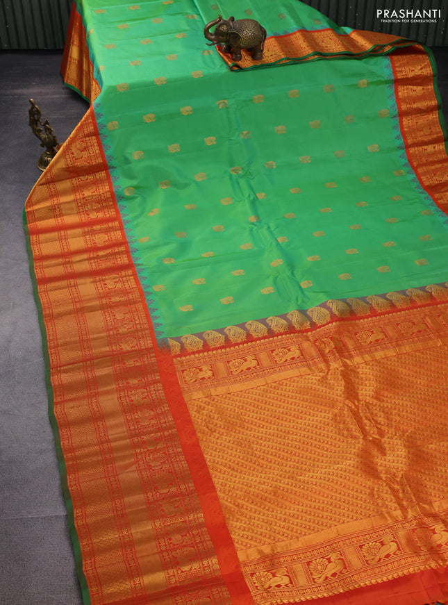 Pure gadwal silk saree light green and orange with annam zari woven buttas and temple design zari woven border