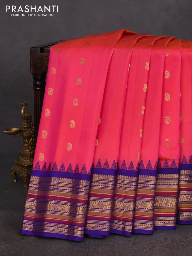Pure gadwal silk saree dual shade of pinkish orange and blue with zari woven buttas and temple design zari woven border