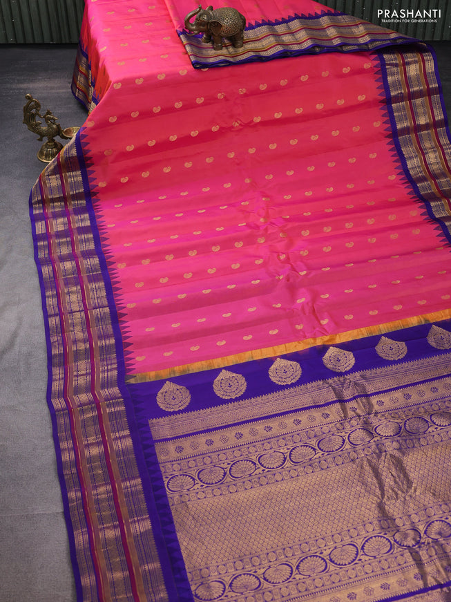 Pure gadwal silk saree dual shade of pinkish orange and blue with zari woven buttas and temple design zari woven border