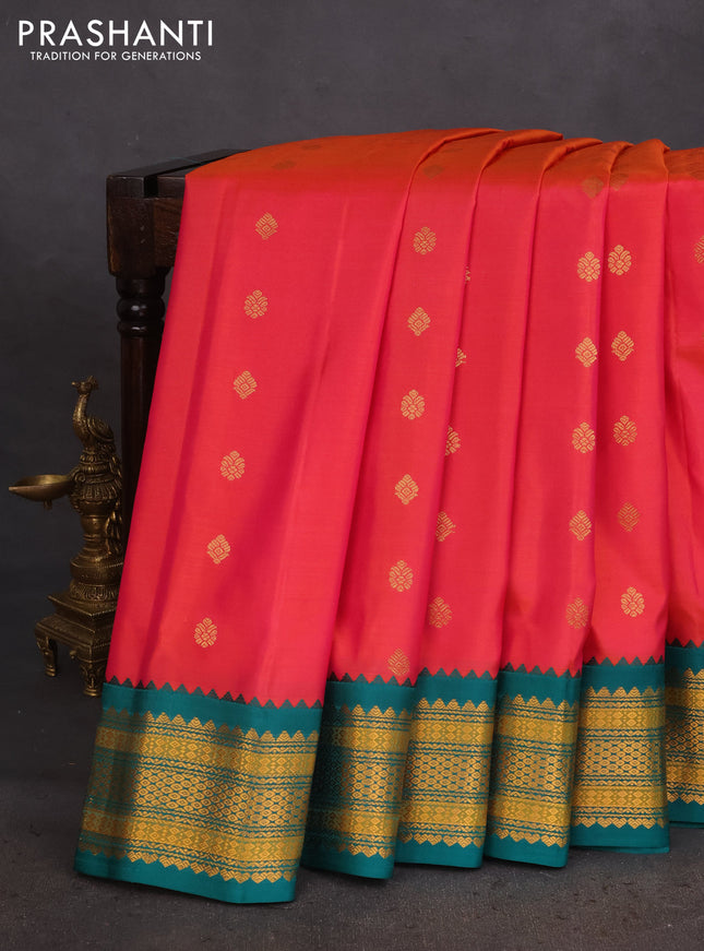 Pure gadwal silk saree dual shade of pinkish orange and teal green with zari woven buttas and temple design zari woven border