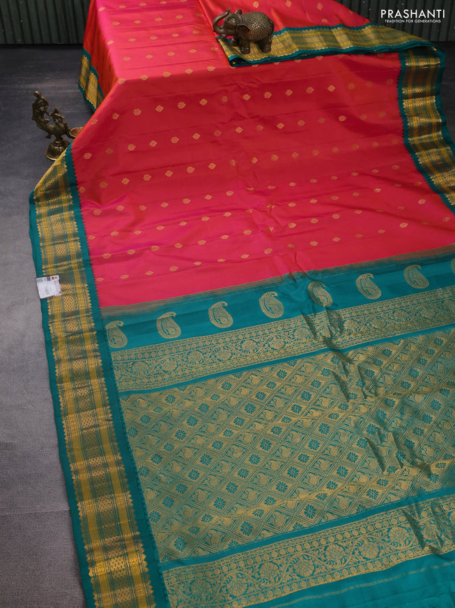 Pure gadwal silk saree dual shade of pinkish orange and teal green with zari woven buttas and temple design zari woven border