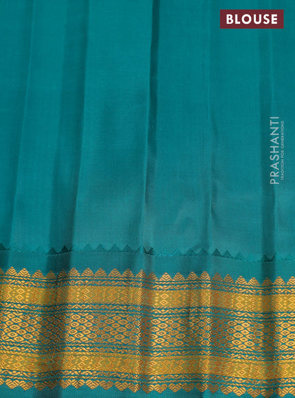 Pure gadwal silk saree dual shade of pinkish orange and teal green with zari woven buttas and temple design zari woven border