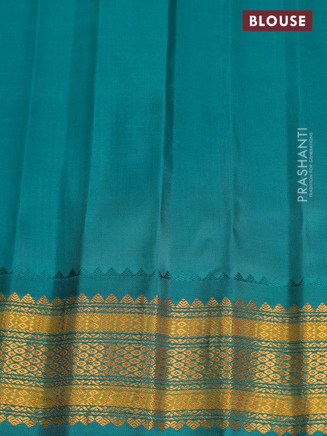 Pure gadwal silk saree dual shade of pinkish orange and teal green with zari woven buttas and temple design zari woven border