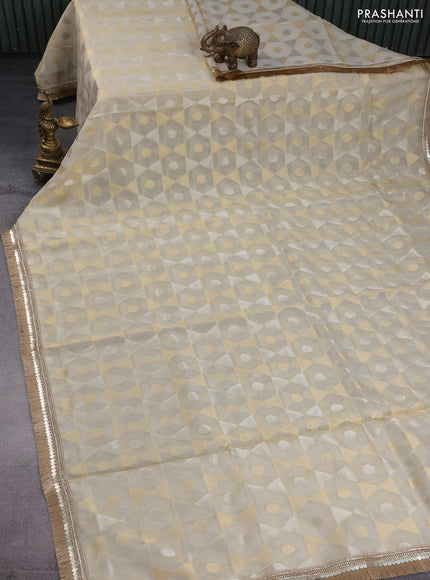 Banarasi tissue saree beige and mustard yellow with allover zari woven geometric wevaes and lace work border