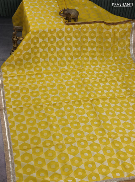 Banarasi tissue saree yellow and red with allover zari woven geometric wevaes and lace work border