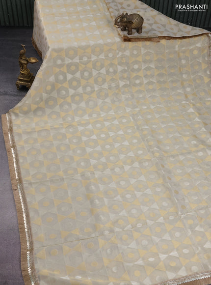 Banarasi tissue saree beige and red with allover zari woven geometric wevaes and lace work border