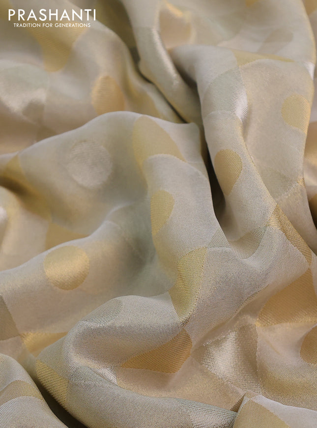 Banarasi tissue saree beige and red with allover zari woven geometric wevaes and lace work border