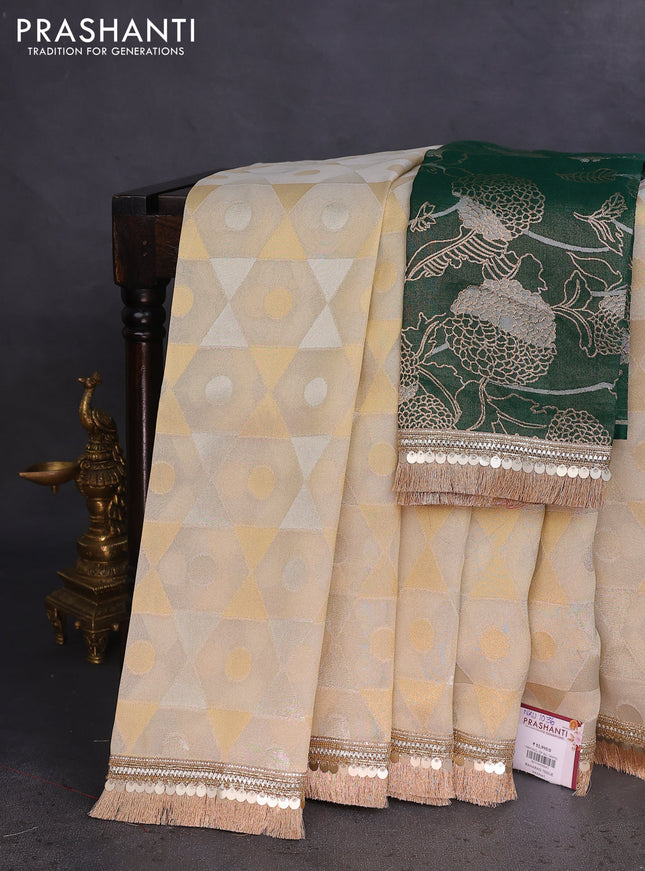 Banarasi tissue saree beige and dark green with allover zari woven geometric wevaes and lace work border