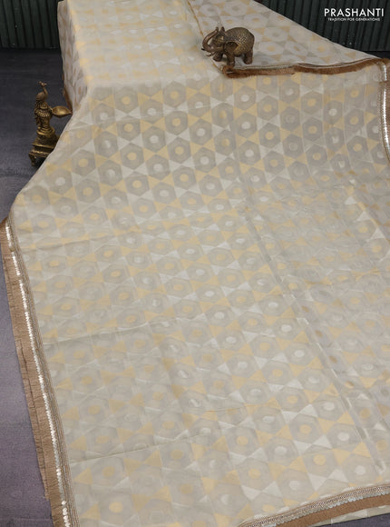 Banarasi tissue saree beige and violet with allover zari woven geometric wevaes and lace work border