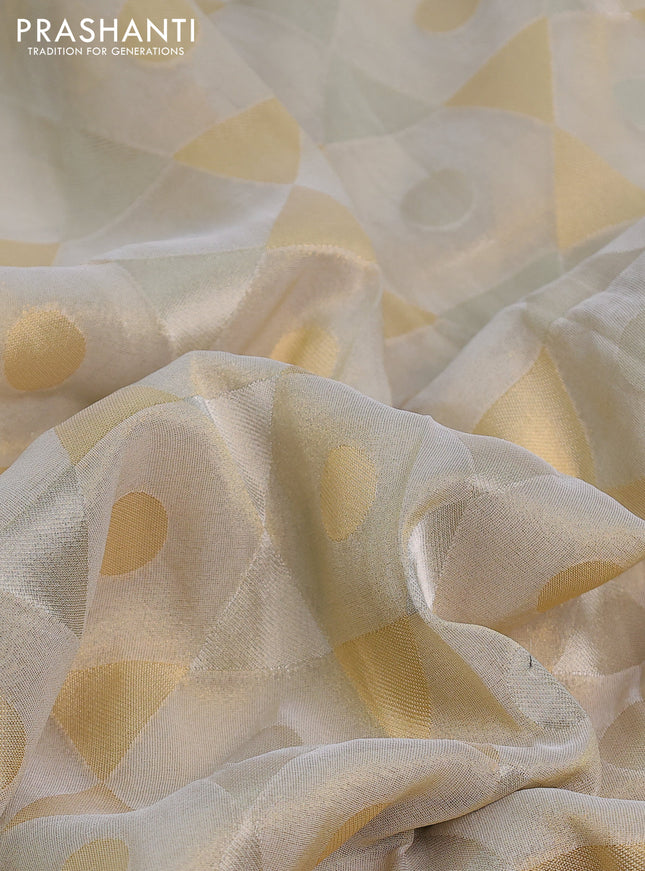 Banarasi tissue saree beige and violet with allover zari woven geometric wevaes and lace work border