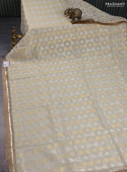 Banarasi tissue saree beige and pink with allover zari woven geometric wevaes and lace work border