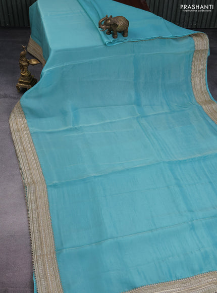 Banarasi tissue saree teal blue with plain body and lace work border