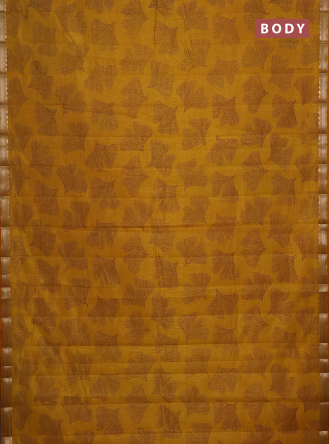 Semi raw silk saree mustard yellow with allover leaf butta prints and zari woven border