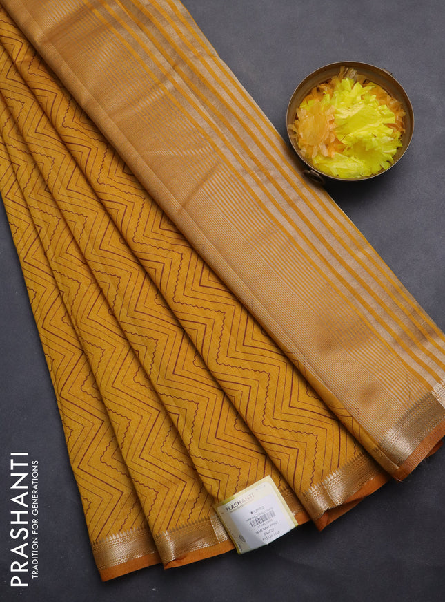 Semi raw silk saree mustard yellow with allover zig zag prints and zari woven border