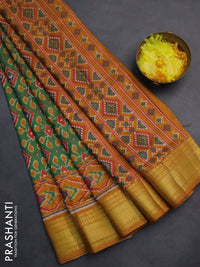 Semi tussar saree green and dark mustard with allover ikat prints and zari woven border