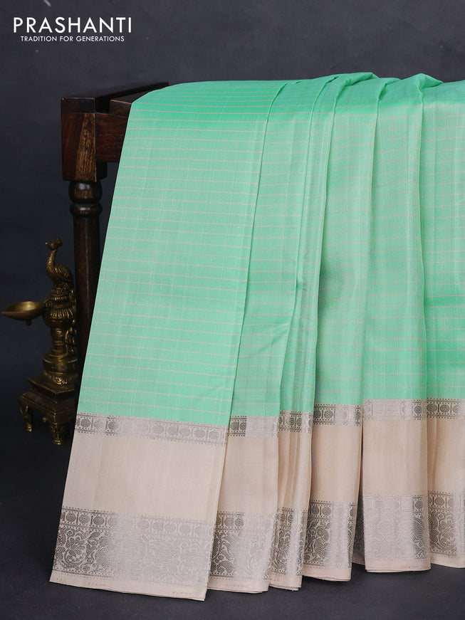 Pure soft silk saree teal green shade and beige with allover checked pattern and rettapet silver zari woven border