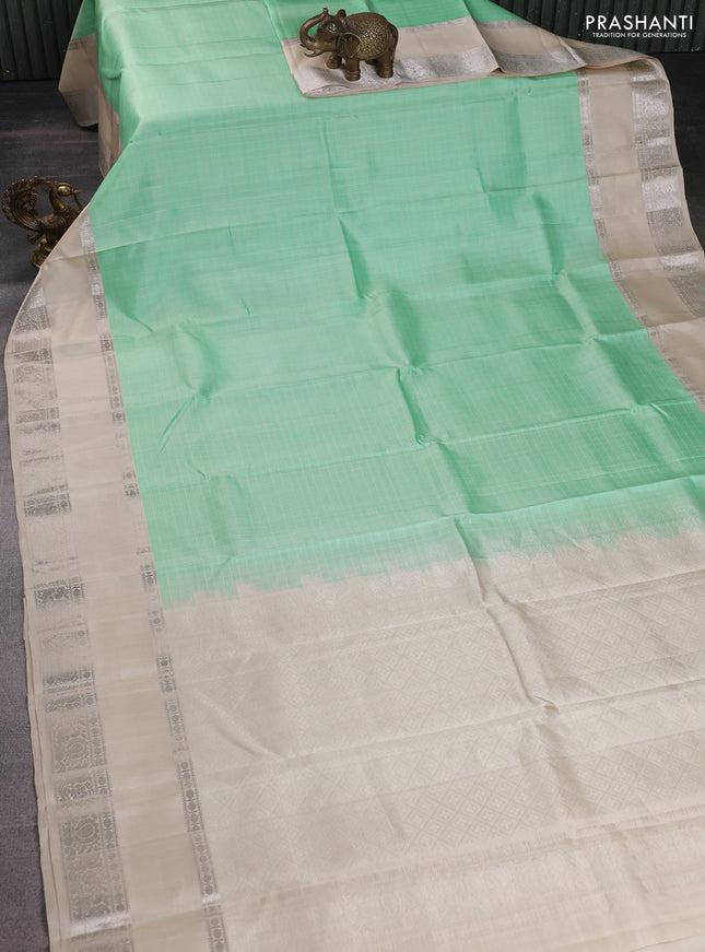 Pure soft silk saree teal green shade and beige with allover checked pattern and rettapet silver zari woven border