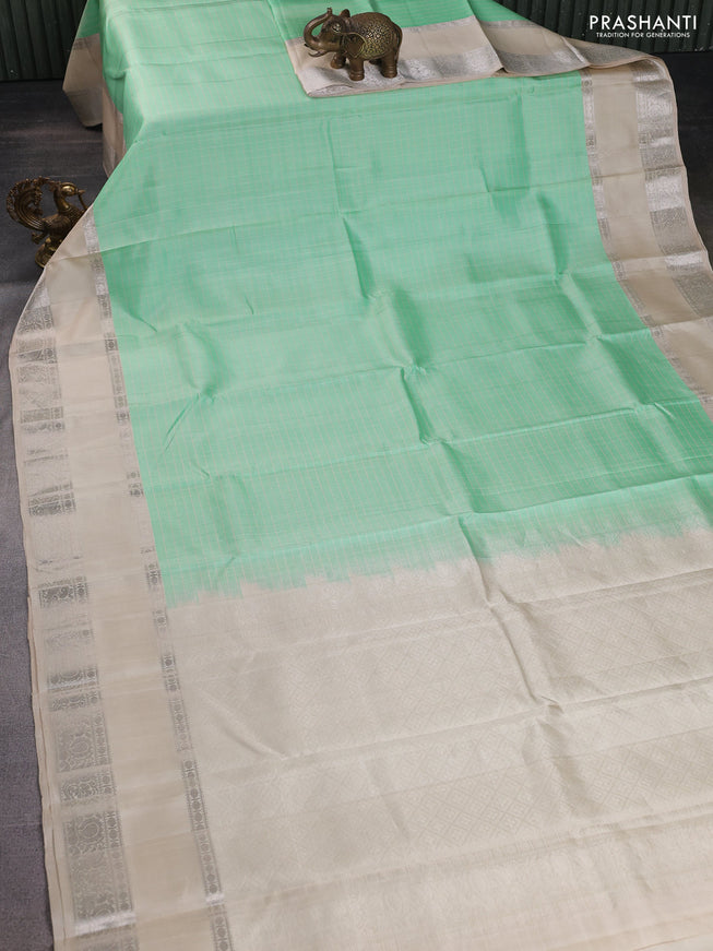 Pure soft silk saree teal green shade and beige with allover checked pattern and rettapet silver zari woven border