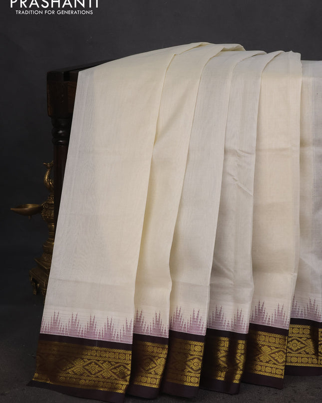 Silk cotton saree off white and coffee brown with plain body and temple design zari woven korvai border
