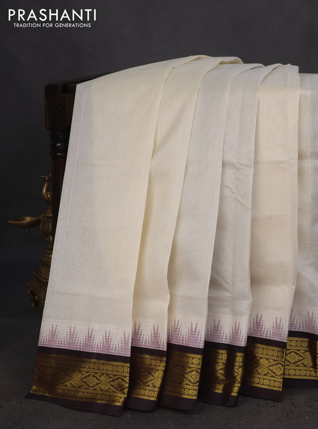 Silk cotton saree off white and coffee brown with plain body and temple design zari woven korvai border