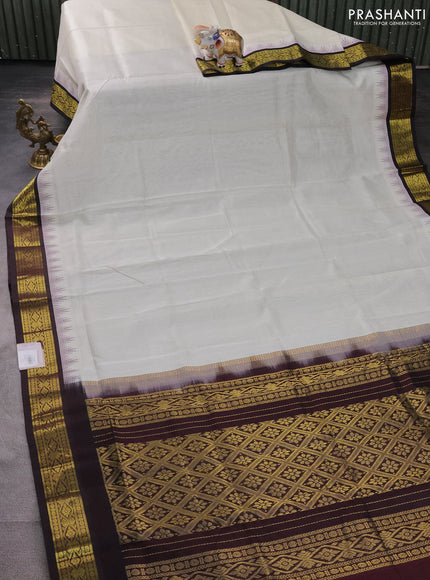 Silk cotton saree off white and coffee brown with plain body and temple design zari woven korvai border