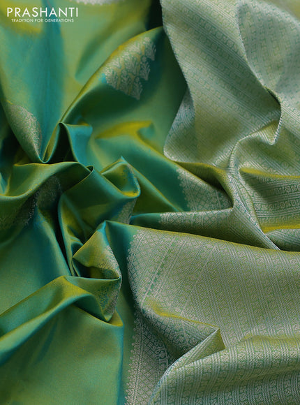Pure kanchipuram silk saree dual shade of teal bluish green with self emboss & silver zari buttas and silver zari woven border