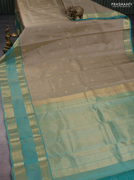 Pure kanchipuram silk saree beige and teal green shade with zari woven buttas and long rettapet zari woven border