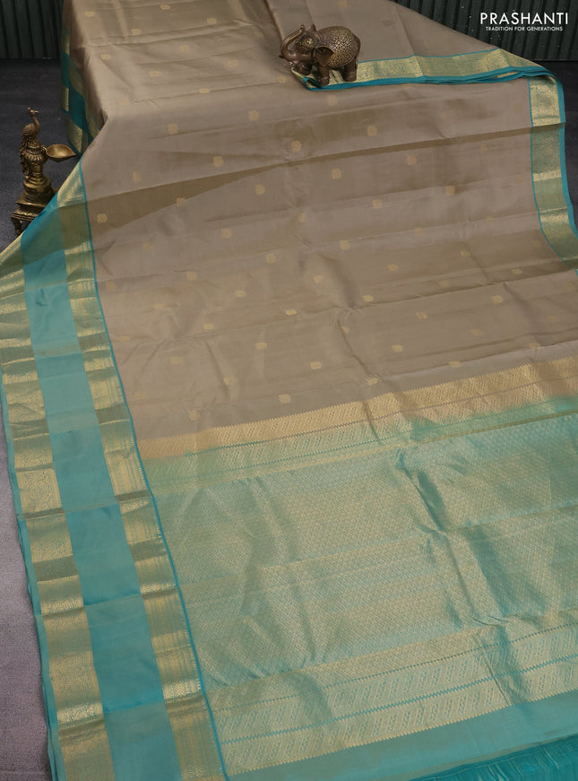 Pure kanchipuram silk saree beige and teal green shade with zari woven buttas and long rettapet zari woven border