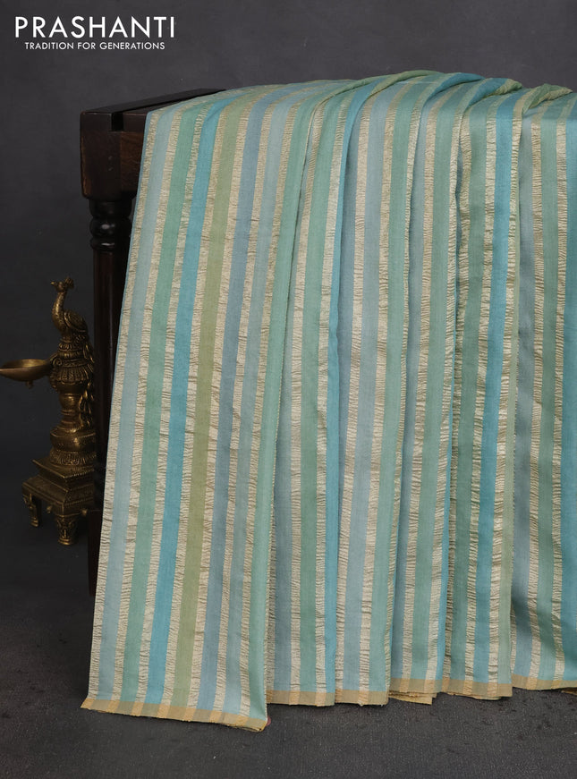 Munga silk saree pastel blue with allover zari woven stripes pattern in borderless style