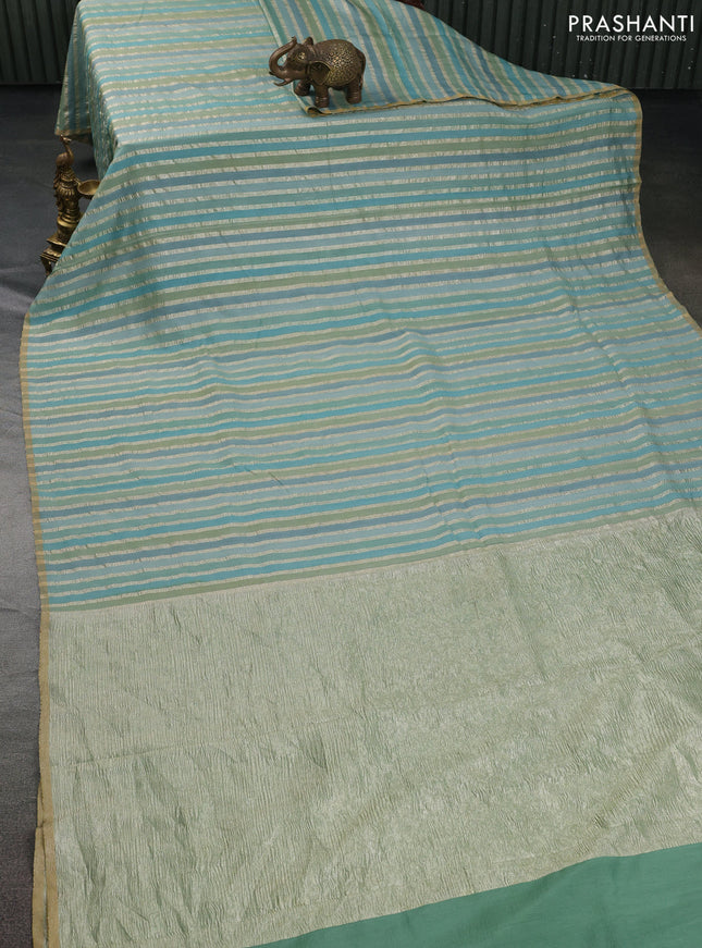 Munga silk saree pastel blue with allover zari woven stripes pattern in borderless style